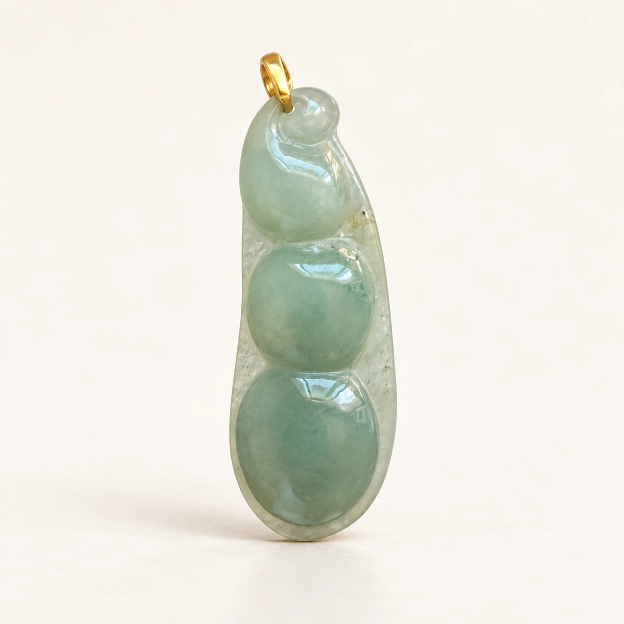 Three-Bean Jade Pendant — studio background edit of supplied product photo