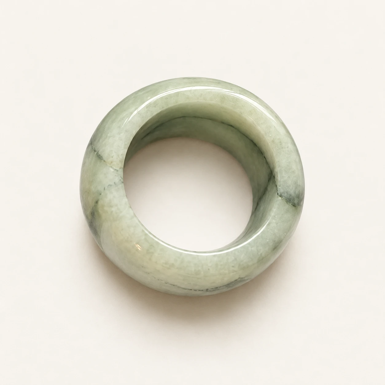 Celadon Wide Jade Ring — studio background edit of supplied product photo