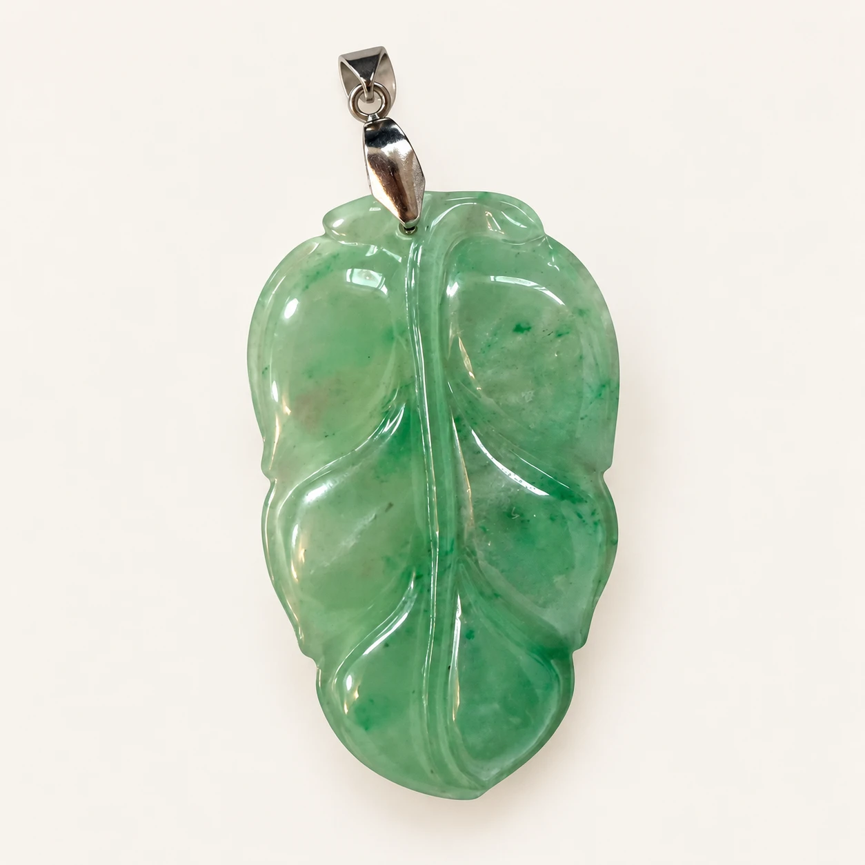 Jade Leaf Pendant — studio background edit of supplied product photo